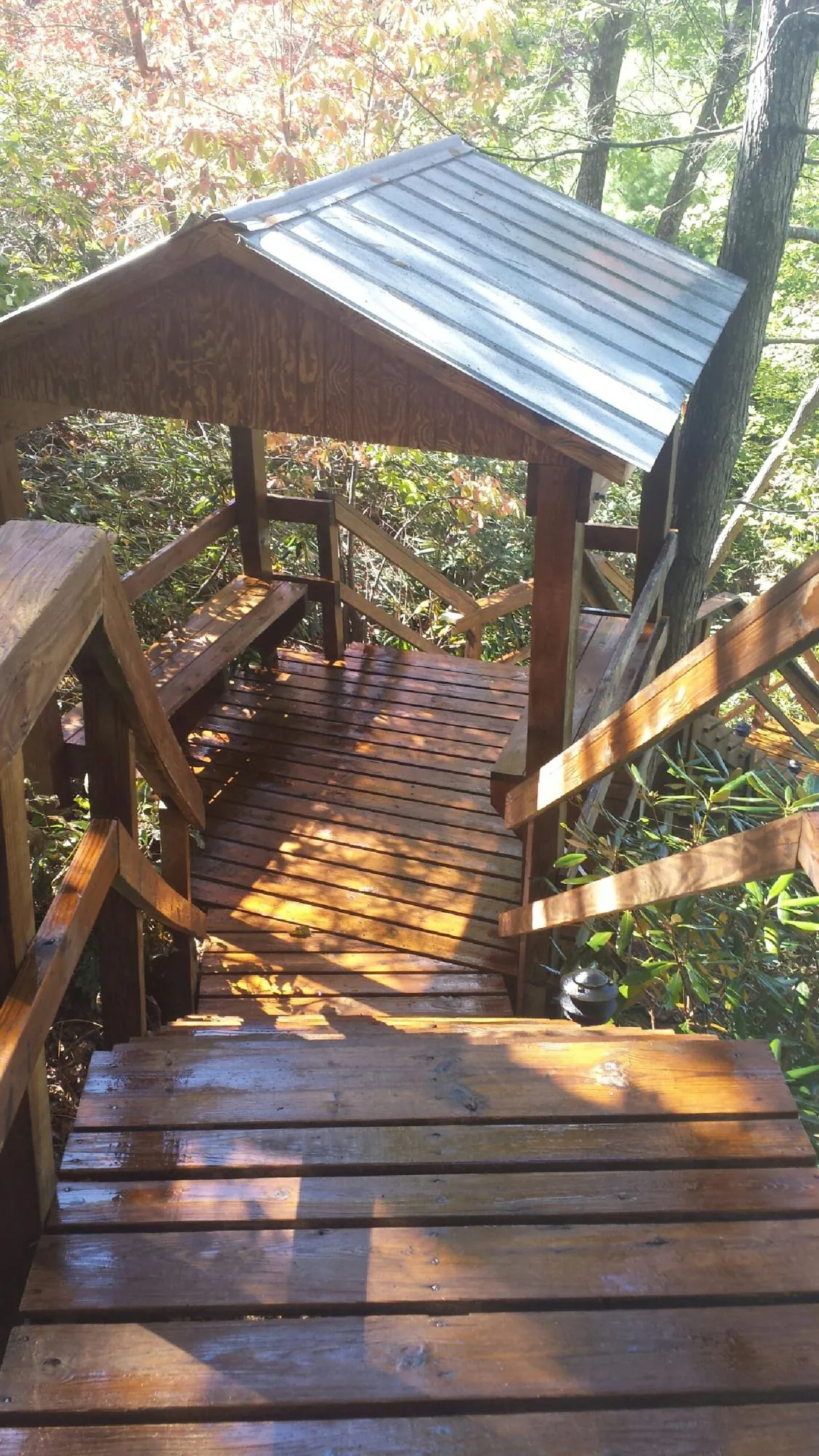 Freshly stained wood walkway and covered shelter with a metal roof in Highland Park